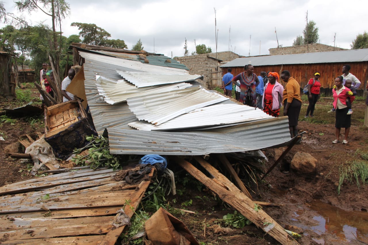 Laikipia East Deputy County Commissioner Patrick Muli (clad with beret) issuing food aid to Likii informal settlement flood victim on Friday, May 10,2024. More than 20 affected families benefitted. (Photo by Muturi Mwangi/KNA)